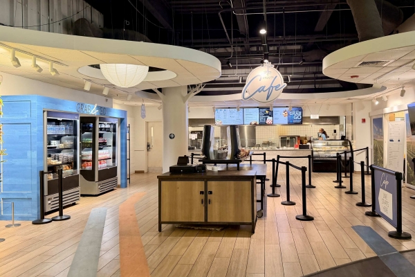 A small cafe with a counter, registers, and several scansions to form a line at OSC.