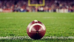 An American football on a green field