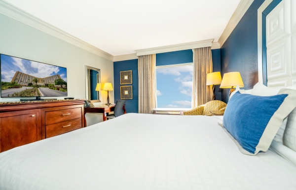 A clean, brightly colored guest room with a window view at Rosen Plaza Hotel on International Drive in Orlando.