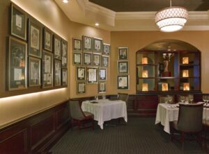 Caricatures hang on the wall at Jack's Place, an award-winning steakhouse and true hidden gem.