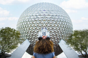 Solo travel fan standing outside Spaceship Earth at EPCOT