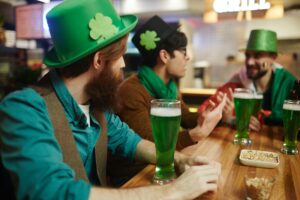 People drinking green beer at an Irish bar on St. Paddy's Day