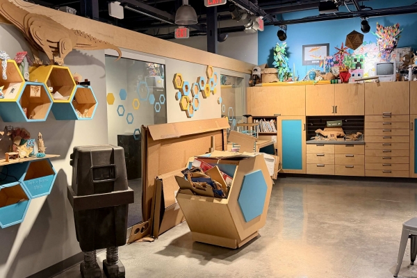 A workshop space with lots of cabinets and bins of materials like cardboard.
